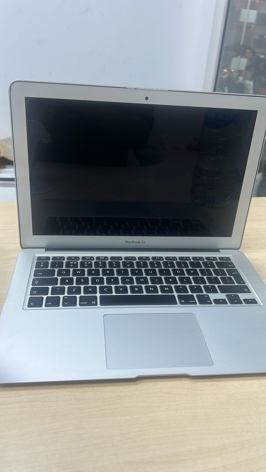 Laptop on a wooden surface with a blurred background