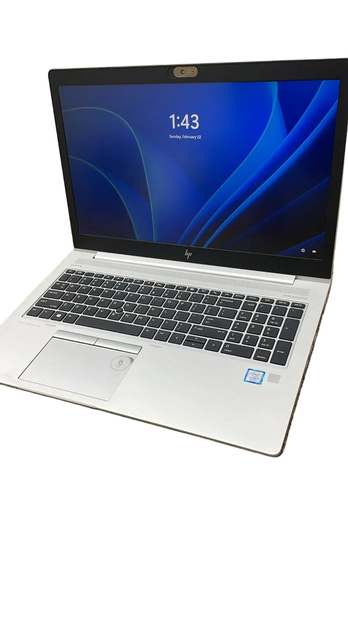 Laptop on a carpeted floor with a blurred background