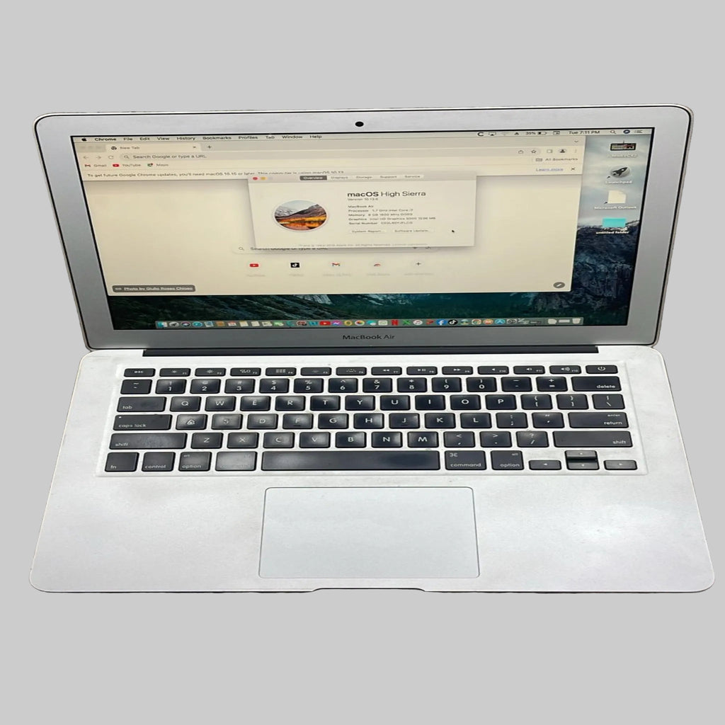 Silver laptop on a brown surface